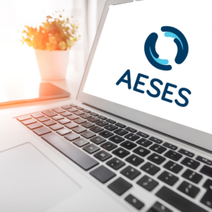 A photo of a laptop with the AESES logo on the screen.